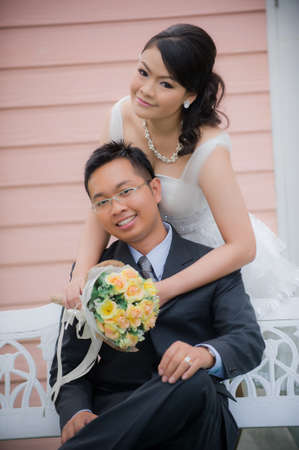 Bride and Groom posing in wedding dress at studio, smilingの写真素材