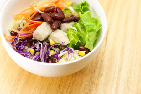 Delicious vegetable salad on wooden boardの写真素材