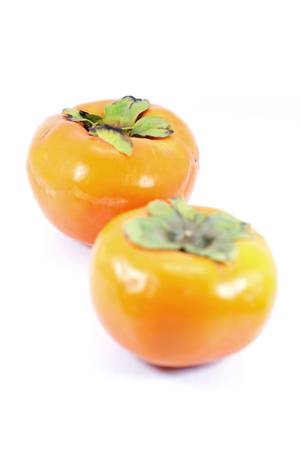 Two ripe persimmons isolated on white の写真素材