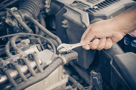 Hands of car mechanic in auto repair service の写真素材
