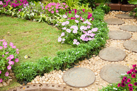 Stone Paved Garden Path with a Lawn and Flowerbedの写真素材