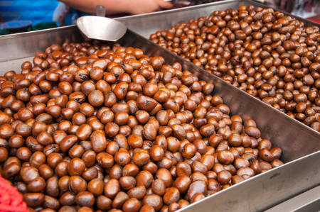 pile of roasted chestnut for retail sale in marketの写真素材