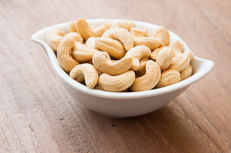cashew nuts on white dishの写真素材
