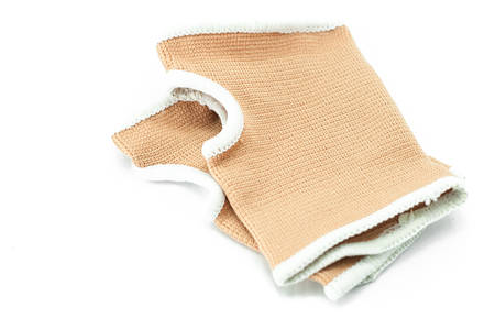Male hand gesturing wearing blue neoprene wrist support over white.の写真素材