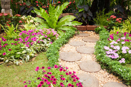 Stone Paved Garden Path with a Lawn and Flowerbedの写真素材