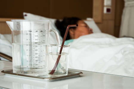 Glass of water in hospital roomの写真素材