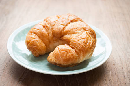 breakfast with croissants, cup of black coffeeの写真素材