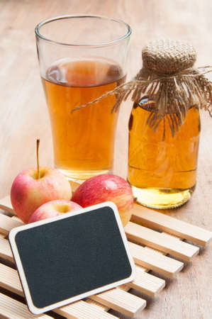 Glasses of apple juice with apples on the background.の写真素材