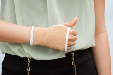 Close-up hand splint for broken bone treatment isolated on white backgroundの写真素材