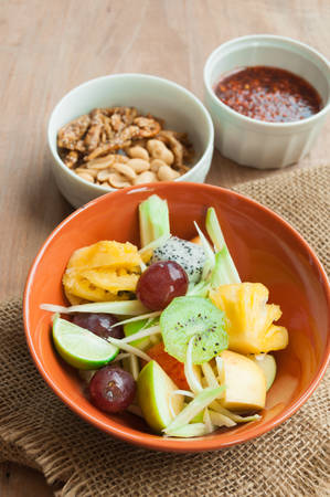 Delicious fruits salad in plate on table close-upの写真素材