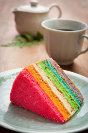 Delicious rainbow cake on plate on tableの写真素材