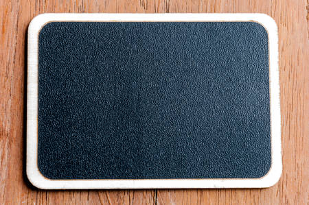 Blackboard on wooden backgroundの写真素材
