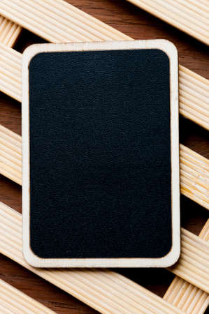 Blackboard on wooden backgroundの写真素材