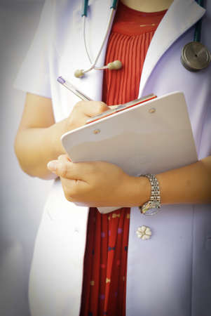 doctor writing on clipboardの写真素材