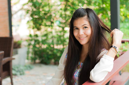 fashion indoor photo of beautiful smiling girl, relaxing timeの写真素材