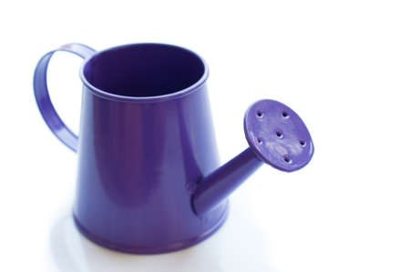 purple watering can. It is isolated on a white の写真素材