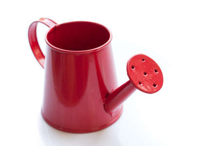 Red watering can. It is isolated on a white の写真素材