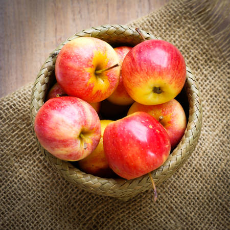 Red Juicy Apples Placed in a Basketの写真素材