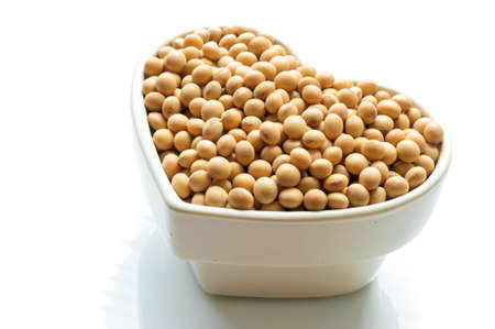 Soy beans in a white bowl isolated on white backgroundの写真素材