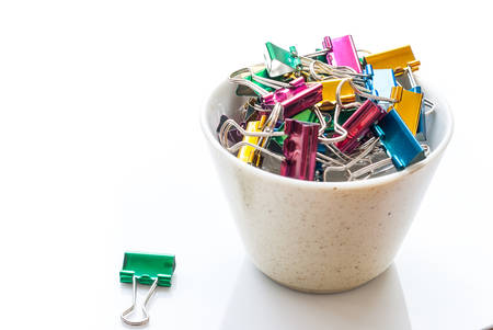 Heap of binder clips isolated on white