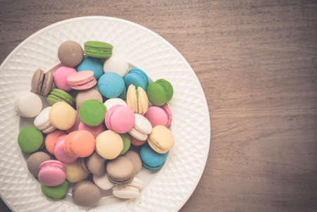 French macaroons. Coffee, chocolate, vanilla and raspberry macaroons, vintage toneの写真素材