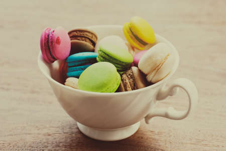 French macaroons. Coffee, chocolate, vanilla and raspberry macaroons, vintage toneの写真素材