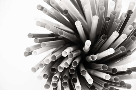 plastic drinking straws on a white background, black and white toneの写真素材