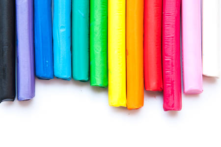 Rainbow colors plasticine play dough modeling clay isolated over white.の写真素材
