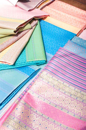 artistic variety shade tone colors ornaments patterns of thai silk textiles with traditional cultural decoration ornaments design by village people for sale in a street marketの写真素材