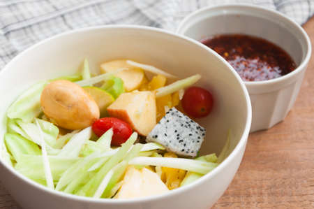 Delicious fruits salad in plate on table close-upの写真素材