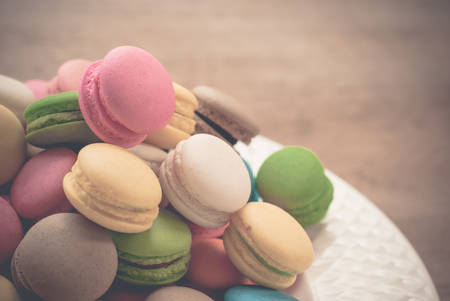 French macaroons. Coffee, chocolate, vanilla and raspberry macaroons, vintage toneの写真素材