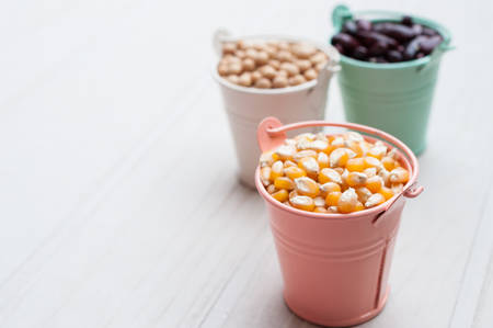 Different kinds of bean seeds lentil peas in dish on wooden table macrobiotic food or healthy foodの写真素材