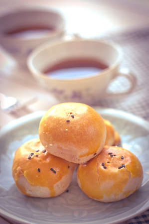 Chinese pastry moon cake with cup of tea