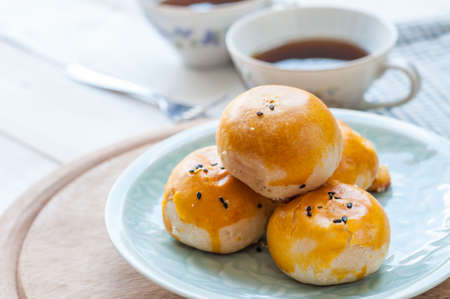 Chinese pastry moon cake with cup of teaの写真素材