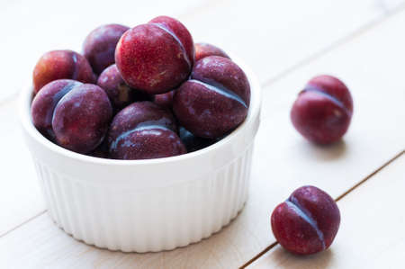 Sweet plums on wooden backgroundの写真素材