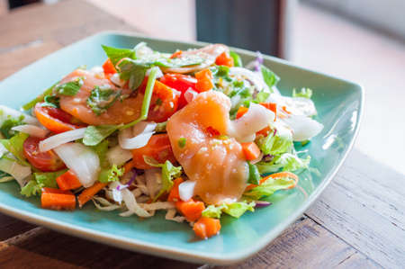 Spicy salmon salad with mixed vegetable and herbの写真素材