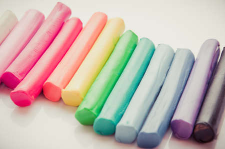 Rainbow colors plasticine play dough modeling clay isolated over white.pastelの写真素材