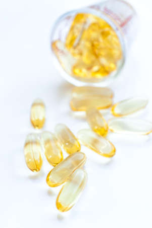 Fish oil capsule isolated on white, health care and medical concept