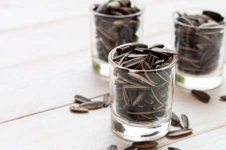 Close up sunflower seed in ceramic dish isolated on white - with pathの写真素材