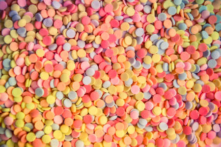 Sugar sprinkle dots, decoration for cake and bekery, a lot of sprinkles as a backgroundの写真素材