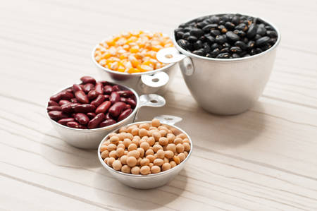 collection set of beans, legumes, peas, lentils on white wooden board.