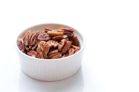 pecan nuts in wood bowlの写真素材