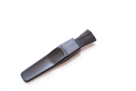 Lens brush for cleaning camera on a white background