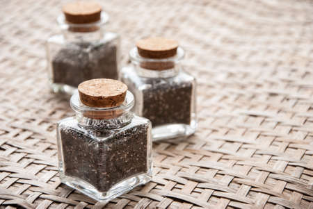 heap of chia seeds, on wooden boardの写真素材