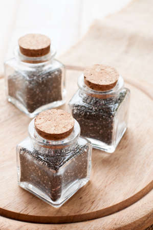 heap of chia seeds, on wooden boardの写真素材