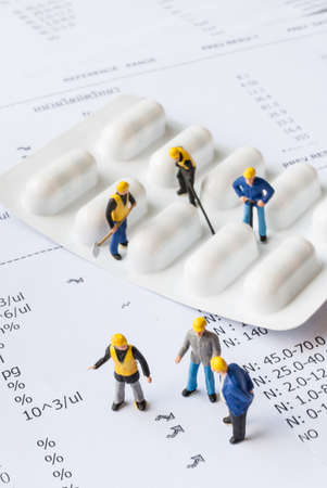 miniature people on the drugs or pils with medical check up lab result, medical conceptの写真素材