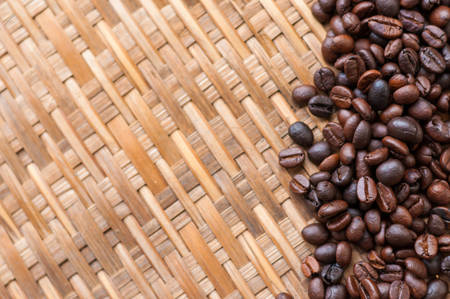 Coffee Beans in white spoon on wooden backgroundの写真素材