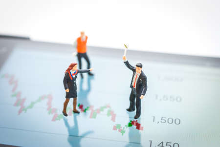 stock market graph, data analyzing with miniature peopleの写真素材