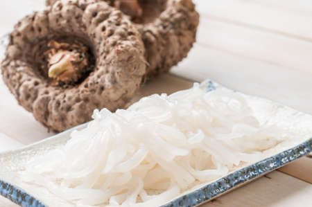 Shirataki noodle, konjac on white wooden boardの写真素材