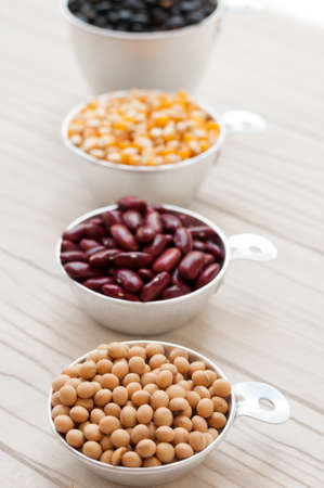 collection set of beans, legumes, peas, lentils on white wooden board.